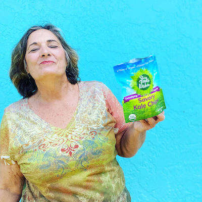 felicia-holding-kale-chips-blue-background